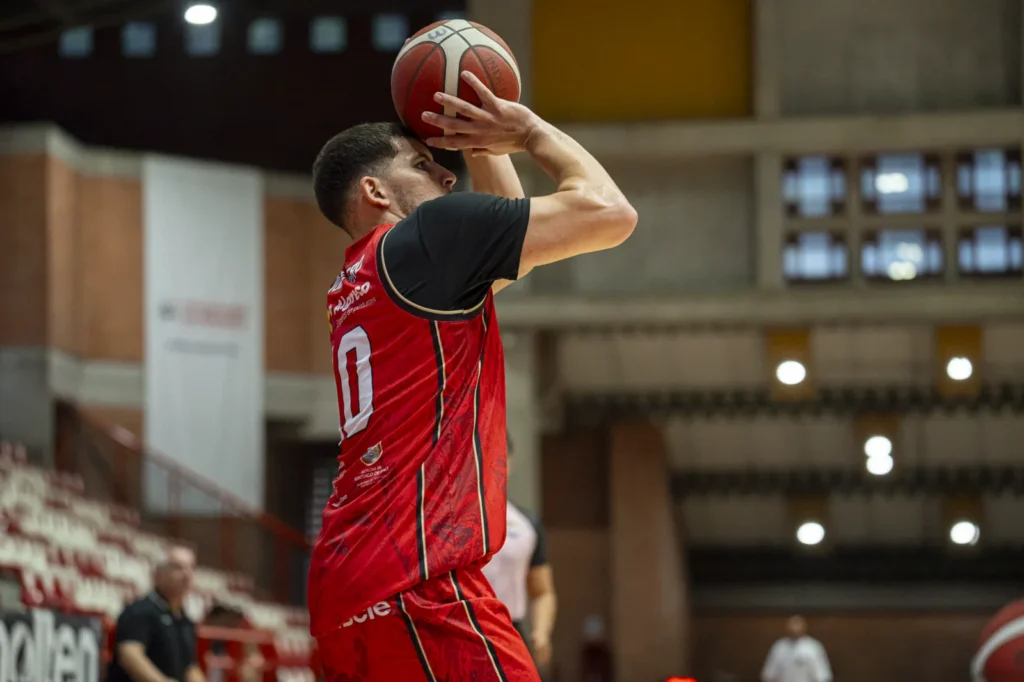 Jugador de Toros del Valle eleva el balón para lanzar ante Paisas Basketball en Medellín